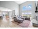 Bright open floor plan featuring a large sectional, dining area, and a stone fireplace at 4253 Ironclad Dr, Bargersville, IN 46106