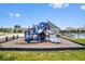 A colorful playground with a slide, climbing structure and safety surface, and a fenced pool in background at 4253 Ironclad Dr, Bargersville, IN 46106