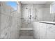 Bright bathroom features a marble-tiled shower with glass door, built-in seat, and window at 4253 Ironclad Dr, Bargersville, IN 46106