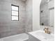Bathroom showcasing a modern vanity, gold hardware, and tiled walls at 4502 Evanston Ave, Indianapolis, IN 46205
