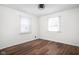 Bright bedroom featuring hardwood flooring and natural light from two windows at 4502 Evanston Ave, Indianapolis, IN 46205