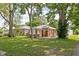 Charming single-story brick home surrounded by mature trees at 4502 Evanston Ave, Indianapolis, IN 46205
