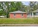 Cozy single-story brick home with manicured lawn and mature trees at 4502 Evanston Ave, Indianapolis, IN 46205