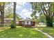 Charming single-story brick home surrounded by lush greenery at 4502 Evanston Ave, Indianapolis, IN 46205