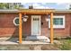 A cozy front porch with wooden support beams and hanging flower baskets at 4502 Evanston Ave, Indianapolis, IN 46205