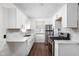 Updated kitchen with stainless steel appliances and white cabinets at 4502 Evanston Ave, Indianapolis, IN 46205