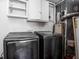 Practical laundry room with modern machines and overhead storage at 4502 Evanston Ave, Indianapolis, IN 46205