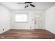 Bright, airy living room with modern flooring and a ceiling fan at 4502 Evanston Ave, Indianapolis, IN 46205