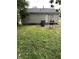 The backyard features a well-maintained lawn, exterior door and a grill at 4744 E 33Rd St, Indianapolis, IN 46218