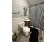 Cozy bathroom featuring vanity, toilet, mirror and unique shower curtain at 4744 E 33Rd St, Indianapolis, IN 46218