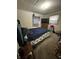 Bedroom with blue bedding, a television, and an exterior window at 4744 E 33Rd St, Indianapolis, IN 46218