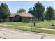 Well-maintained single-story brick home with manicured lawn, mature trees, and corner street view at 4910 Bowie Dr, Anderson, IN 46013