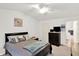 Bright bedroom featuring a ceiling fan, ensuite bathroom, and neutral decor at 5011 Amber Creek Pl # 310, Indianapolis, IN 46237