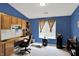 Blue home office features a built-in desk, cabinets, and natural light at 5011 Amber Creek Pl # 310, Indianapolis, IN 46237