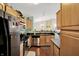 Bright kitchen features stainless steel appliances, wood cabinets, and a view into the dining area at 5011 Amber Creek Pl # 310, Indianapolis, IN 46237