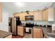 Well-equipped kitchen featuring stainless steel appliances, wooden cabinets, and ample counter space at 5011 Amber Creek Pl # 310, Indianapolis, IN 46237