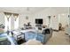 Bright living room with vaulted ceiling, ceiling fan, cozy seating, and sliding glass doors to a balcony at 5011 Amber Creek Pl # 310, Indianapolis, IN 46237