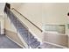 Carpeted stairwell with handrails and mailboxes; upper and lower levels at 5011 Amber Creek Pl # 310, Indianapolis, IN 46237