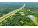 Sprawling wooded acreage with nearby highway, featuring a private home nestled among mature trees at 5055 Turkey Track Rd, Martinsville, IN 46151