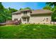 Spacious backyard featuring a wooden deck, lush green lawn and mature trees at 5055 Turkey Track Rd, Martinsville, IN 46151