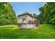 Expansive backyard with above-ground pool, wooden deck, and lush green lawn surrounded by mature trees at 5055 Turkey Track Rd, Martinsville, IN 46151