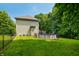 Lush green backyard with a black chain link fence, above-ground pool and wooden deck at 5055 Turkey Track Rd, Martinsville, IN 46151