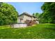 Spacious backyard featuring an above-ground pool with a deck, surrounded by a well-maintained lawn and mature trees at 5055 Turkey Track Rd, Martinsville, IN 46151