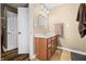 Bathroom featuring a light wood vanity with marble top, mirror, lighting, and tile flooring at 5055 Turkey Track Rd, Martinsville, IN 46151