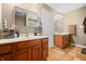 Bathroom featuring dual sinks, marble countertops, tile flooring, and modern fixtures at 5055 Turkey Track Rd, Martinsville, IN 46151