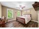 Bedroom features a wood bed, wood floors, two windows, and natural light at 5055 Turkey Track Rd, Martinsville, IN 46151