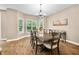 Bright dining room boasts natural light, wood floors, and an elegant chandelier at 5055 Turkey Track Rd, Martinsville, IN 46151