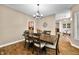 Elegant dining room features a wooden table and view into the kitchen area at 5055 Turkey Track Rd, Martinsville, IN 46151