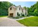 Exterior shot showcasing attached garage, gravel driveway, and manicured lawn at 5055 Turkey Track Rd, Martinsville, IN 46151