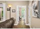 Hallway view showcasing hardwood floors, elegant columns, and doorways leading to other rooms at 5055 Turkey Track Rd, Martinsville, IN 46151