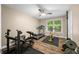 Bright home gym featuring a ceiling fan, workout equipment, and natural light from the large window at 5055 Turkey Track Rd, Martinsville, IN 46151