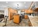 Open kitchen layout boasts wood cabinets, a central island, and modern stainless steel appliances at 5055 Turkey Track Rd, Martinsville, IN 46151