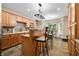 Charming kitchen with wood cabinets, tile backsplash, island seating, and a breakfast nook at 5055 Turkey Track Rd, Martinsville, IN 46151