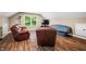 Cozy living room features a leather sofa and tanning bed, creating a relaxing and unique space at 5055 Turkey Track Rd, Martinsville, IN 46151