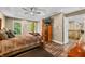 Comfortable main bedroom with tray ceiling, wood floors, and ample natural light at 5055 Turkey Track Rd, Martinsville, IN 46151