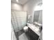 Bathroom featuring a shower with curtain, vanity with sink, and essential amenities at 5103 Covington Ave, McCordsville, IN 46055