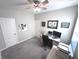 Neutral bedroom featuring gray walls, carpet, ceiling fan, and versatile space for relaxation or work at 5103 Covington Ave, McCordsville, IN 46055