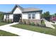 View of the clubhouse featuring brick and siding, professional landscaping, and manicured lawn at 5103 Covington Ave, McCordsville, IN 46055