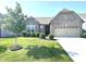 Charming single-Gathering home with a two-car garage, a well-maintained lawn, and mature landscaping at 5103 Covington Ave, McCordsville, IN 46055