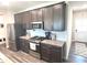 The kitchen features dark cabinetry, stainless steel appliances, and light countertops at 5103 Covington Ave, McCordsville, IN 46055