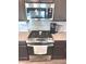The kitchen features stainless steel oven, cooktop and microwave, and light countertops at 5103 Covington Ave, McCordsville, IN 46055
