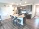 The kitchen has seating for four at the island, modern appliances, and hard surface floors at 5103 Covington Ave, McCordsville, IN 46055