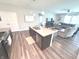 The kitchen features an island that opens to a comfortable living room with a leather couch at 5103 Covington Ave, McCordsville, IN 46055