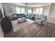 Cozy living room with a leather sofa, an accent chair, and a large window with natural light at 5103 Covington Ave, McCordsville, IN 46055