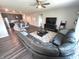 Inviting living room featuring a sectional sofa, a ceiling fan, and an open concept to the kitchen at 5103 Covington Ave, McCordsville, IN 46055