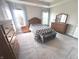 Comfortable main bedroom with a bed, dresser, and natural light that enters through the large windows at 5103 Covington Ave, McCordsville, IN 46055